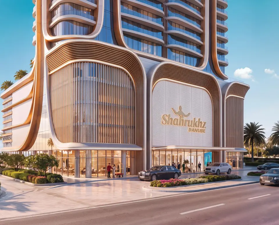 The tower entrance with a landscaped drop-off and the project name on the facade