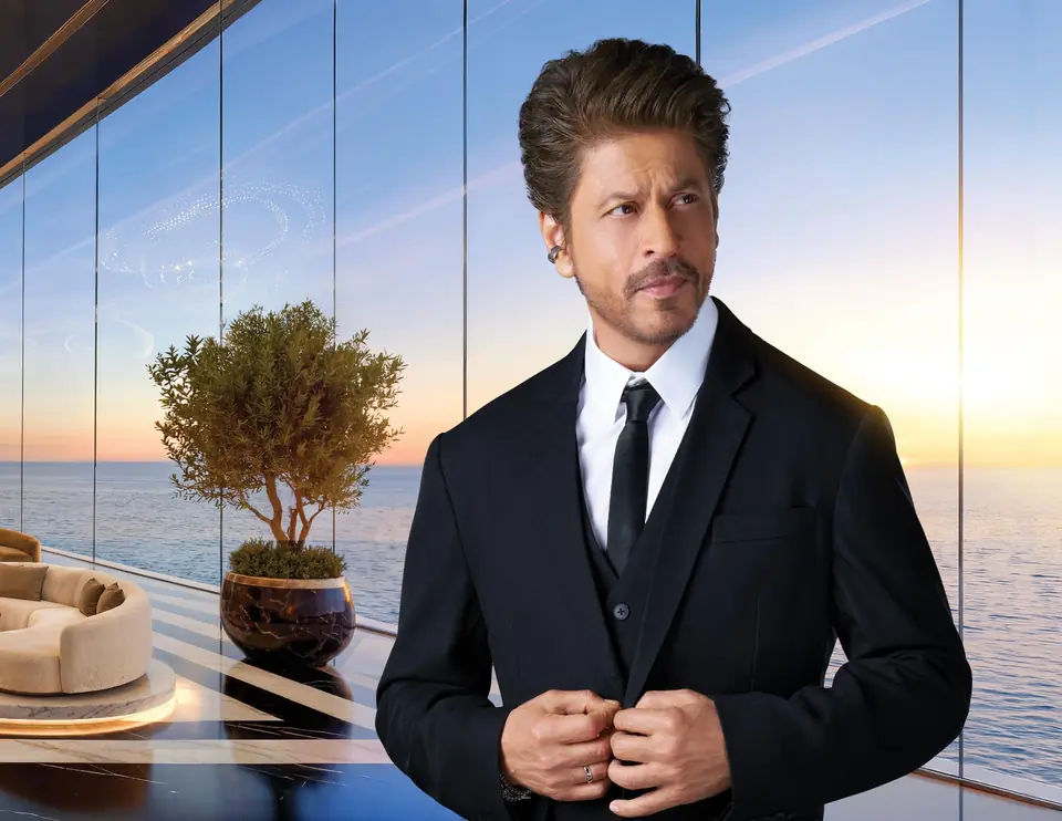 Campaign image of Shah Rukh Khan in a rendering of the King’s Club House at sunset